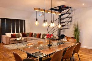 a living room with a table and a couch at Luxury Loft Duplex Penthouse Of 190m2 & Free Parking ! in Brussels
