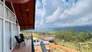 a balcony of a house with a view of the mountains at The Misty Crown in Hatton
