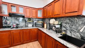 a kitchen with wooden cabinets and granite counter tops at The Misty Crown in Hatton