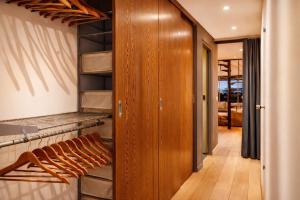 a walk in closet with wood paneling and wooden doors at Luxury Loft Duplex Penthouse Of 190m2 & Free Parking ! in Brussels +21 photos