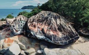 a group of rocks with a turtle painted on them at Seaview Turtle Cove in Kampong Bugis +3 photos