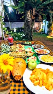 a table with plates of food and fruit on it at Sanithu Homestay and villa Galle in Galle