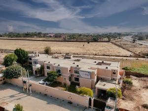 an aerial view of a building and a field at Hotel One Bahawalpur in Bahawalpur