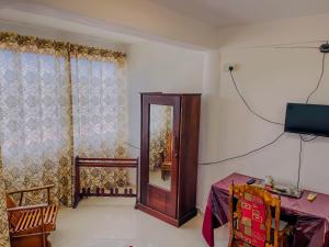 a room with a door and a table and a television at Grand View Hotel Kandy in Kundasale