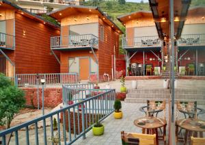 a balcony of a building with tables and chairs at The host in Kanatal