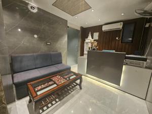 a living room with a couch and a table at Nirvana Bliss By Cosy Homes, Malsi in Dehradun