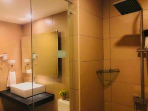 a bathroom with a sink and a shower at Symphony Suites Hotel in Ipoh +23 photos