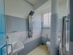 a bathroom with a sink and a toilet and a shower at Grand View Hotel Kandy in Kundasale +27 photos