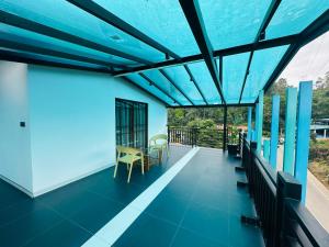 a view from the balcony of a house with a blue ceiling at O2 Resort Welimada in Nugatalawa