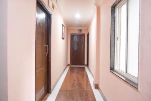 a hallway with a door and a window at FabHotel Rachana Residency - Nr Shivaji Nagar Metro Station in Pune