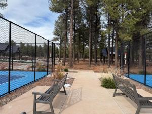 two benches sitting next to a fence next to a pool at McB's Mountain Retreat in Flagstaff