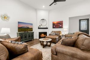 a living room with two couches and a fireplace at McB's Mountain Retreat in Flagstaff