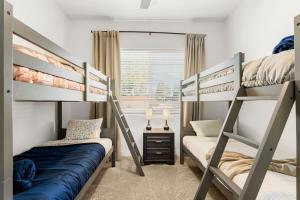 two bunk beds in a room with a window at McB's Mountain Retreat in Flagstaff +73 photos