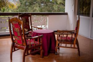 two chairs and a table with a table cloth on it at Grand View Hotel Kandy in Kundasale