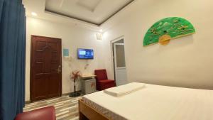 a bedroom with a bed and a desk and a door at Nhật Minh Hotel in Thuan An +33 photos
