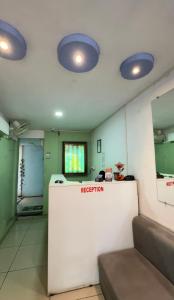 a room with a reception counter and blue lights at The Human Stay in Indore +16 photos