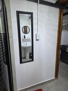 a bathroom with a mirror and a sink at CLP Lodge in Bela-Bela +11 photos