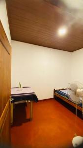 a room with a bed and a table in it at Mangala gust house in Habaraduwa Central