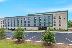 a building with a parking lot in front of it at ECHO Suites Extended Stay by Wyndham Sterling in Sterling