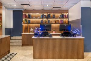 a lobby with a reception desk with christmas decorations at The Quincy, an Ascend Collection Hotel in Washington, D.C.
