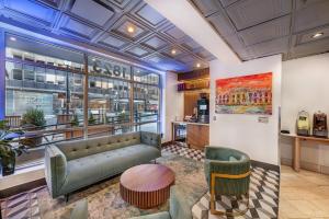 a lobby of a store with a couch and chairs at The Quincy, an Ascend Collection Hotel in Washington, D.C.