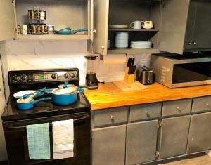 a kitchen with a stove with bowls on it at The Hideout in Moorhead