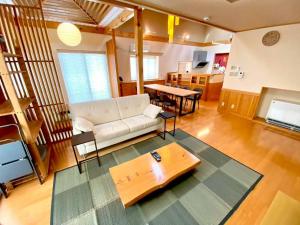 a living room with a couch and a table at Luxury Villa N and N in Aomori