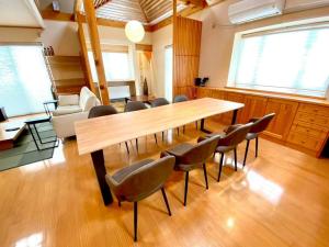 a large room with a wooden table and chairs at Luxury Villa N and N in Aomori