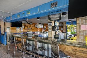 a restaurant with a bar with chairs in it at Studio, kitchenette, pool & Tiki Bar in Sarasota