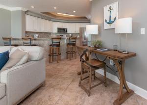 a living room with a couch and a table at Phoenix West 2203 in Orange Beach