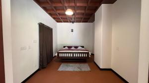 a hallway with a bed in a white room at Colonial canopy in Suntikoppa +12 photos