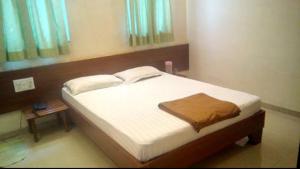 Postel nebo postele na pokoji v ubytování Hotel Rajdeep