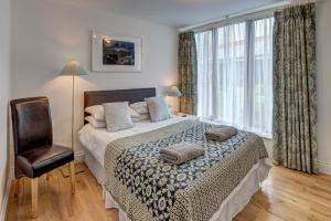 a bedroom with a bed with a chair and a window at Annapurna Guest House in Lingwood