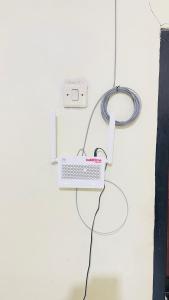 a laptop is plugged into a wall with a cord at sarisare homestay 2BR in Bulakbenda