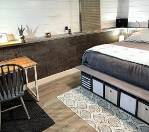a bedroom with a bed and a desk and a chair at The Hideout in Moorhead