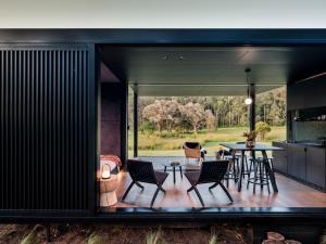 a kitchen and dining area of a house with a table and chairs at The Lantern - a Huch experience in Wollombi