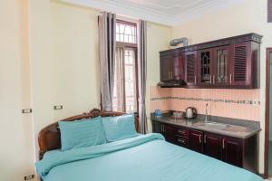 a bedroom with a bed and a sink in it at IL Divo Hostel 8 Hàng Đào & Travel & Spa - Hanoi Old Quarter in Hanoi