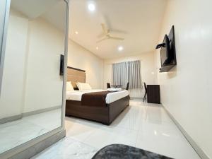 a bedroom with a bed and a sliding glass door at Hotel Center Point in Bhubaneshwar