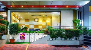 a building with stairs and plants in front of it at Hotel Lals Residency, Adoor in Adūr