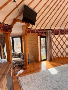 a living room with a flat screen tv in a room at RAHMAT yurts in Bishkek