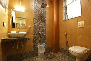 a bathroom with a toilet and a sink and a shower at The Byke - The Sanctuary Heritage - Pan India Pure Veg Hotel Chain in Kumbhalgarh