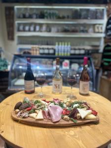 a pizza on a table with two bottles of wine at MmeBassia in Chania