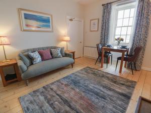 a living room with a couch and a table at North Segganwell - Culzean Castle in Maybole