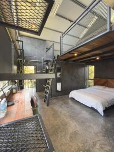 a bedroom with a bed and a spiral staircase at The Lumpang Resort in Kerling +84 photos