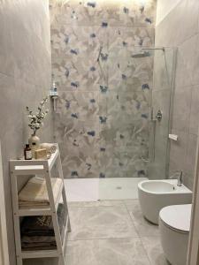 a bathroom with a shower and a toilet and a sink at Aura - Luxury Suite in Syracuse