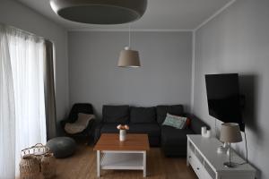 a living room with a couch and a table at Heimathaven 2 in Bremerhaven