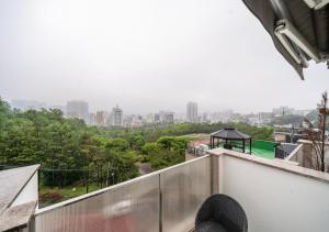 a balcony with a view of a city at Myeongdong Chungmuro Youngin Hotel in Seoul