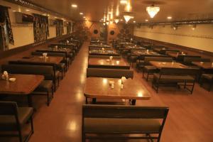 a row of tables and chairs in a restaurant at The Byke Embassy - Surat in Surat