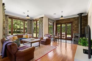 a living room with a couch and a table at Chestnut Tree Farm in Werai