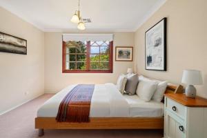 a bedroom with a bed and a window at Chestnut Tree Farm in Werai